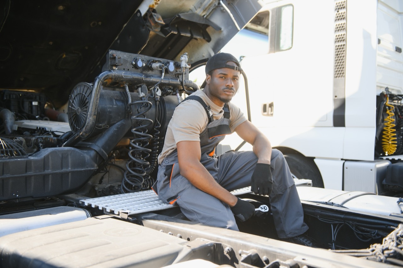 Mechanic working on a semi truck in a repair shop